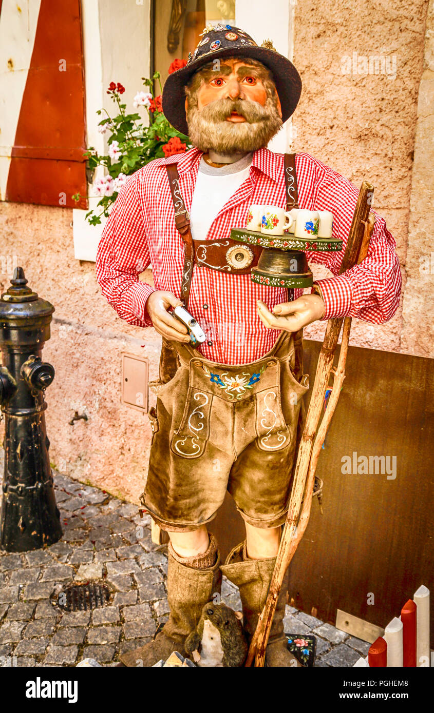 Wooden carving of an old man in lederhosen outside a store in Rattenburg,  Austria Stock Photo - Alamy