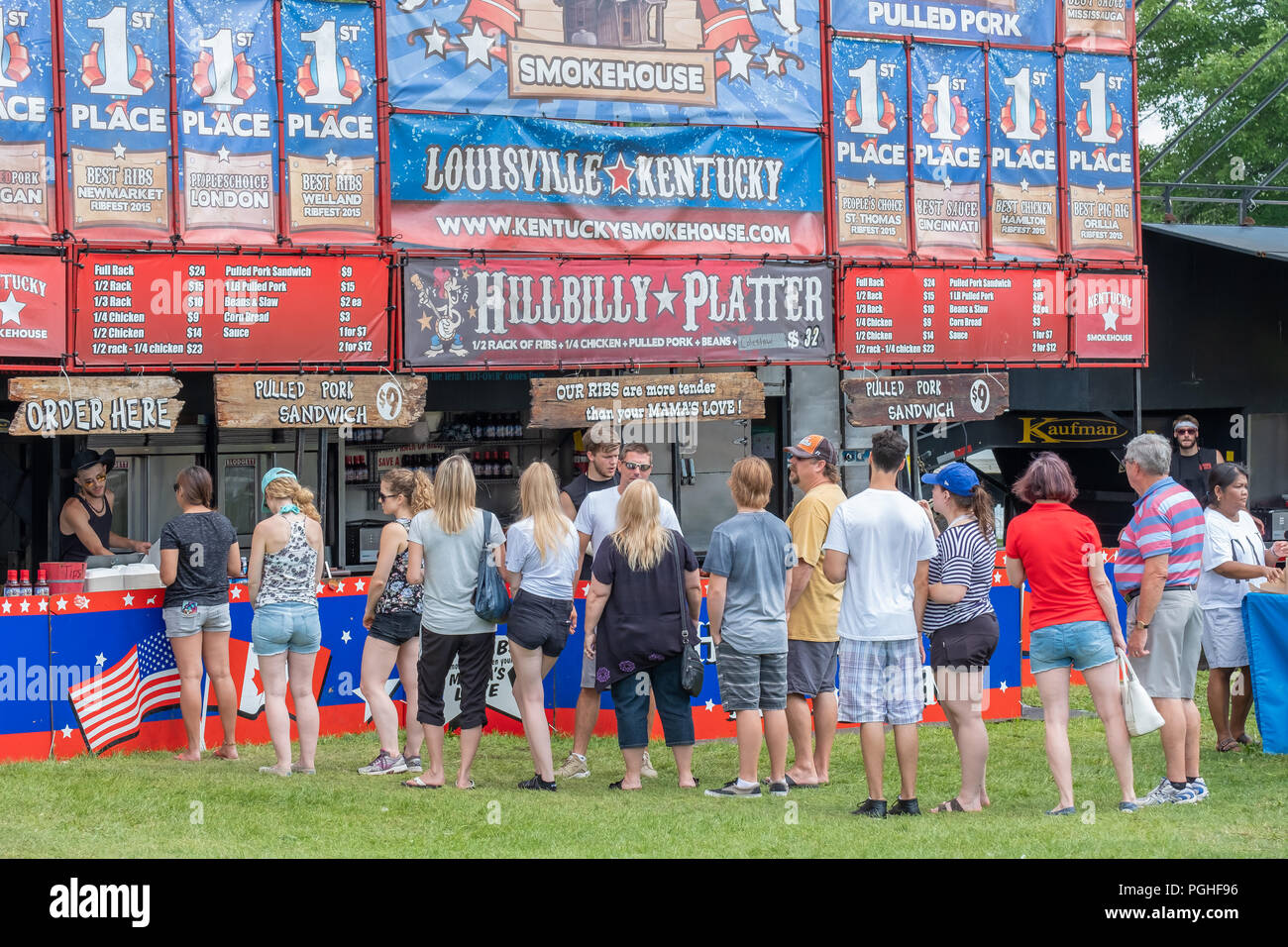 Fans of southern BBQ line up at the favourite pit to enjoy the food at the annual Ribfest in Orillia Ontario Canada. Stock Photo