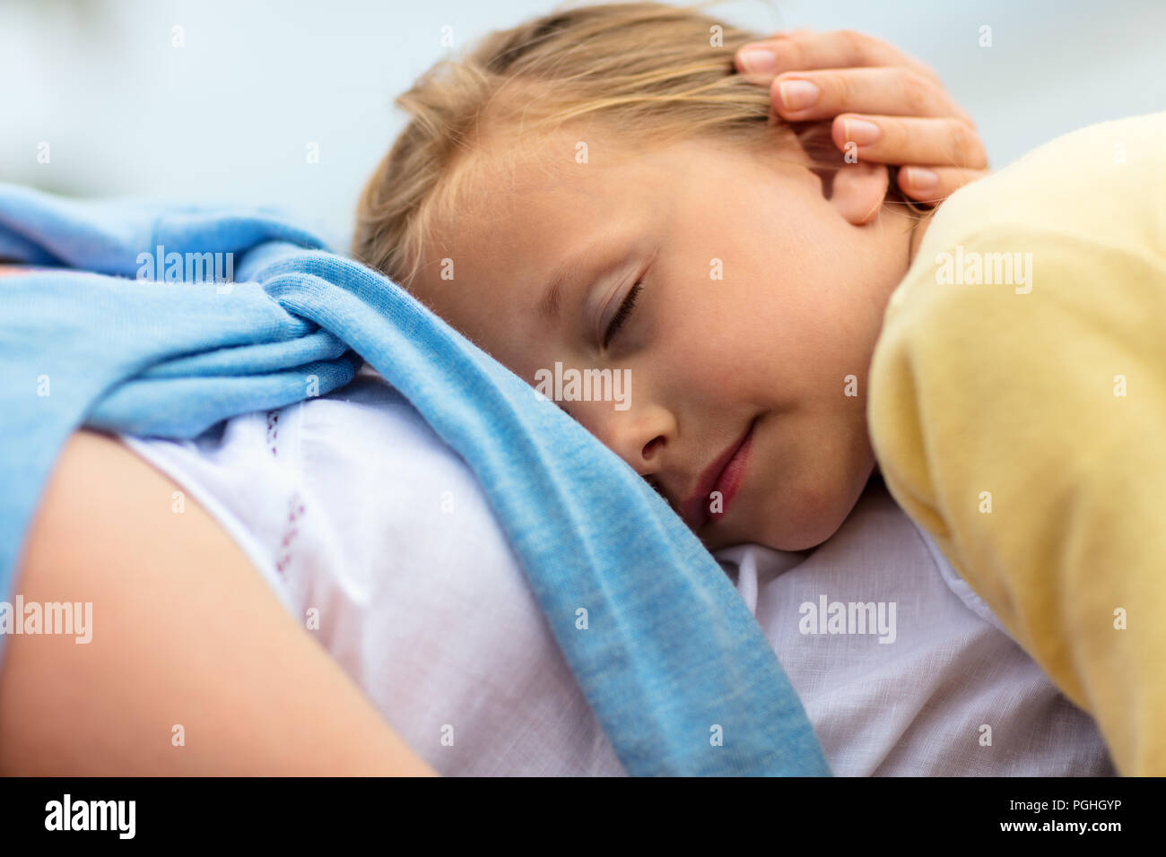 Close up of little girl sleeping on mother lap Stock Photo Alamy
