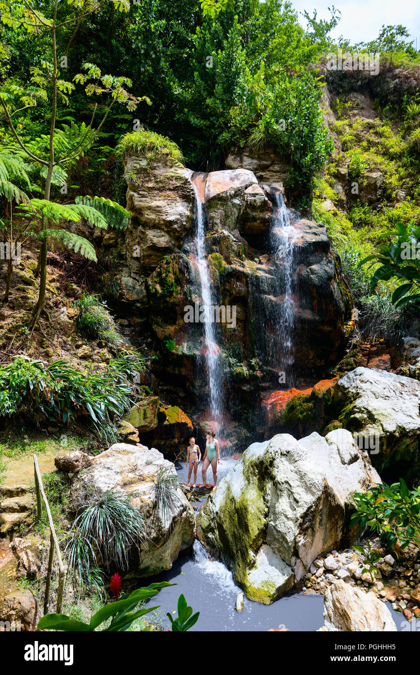 Family of mother and daughter having fun swimming in Sapphire waterfalls on St Lucia island in Caribbean Stock Photo
