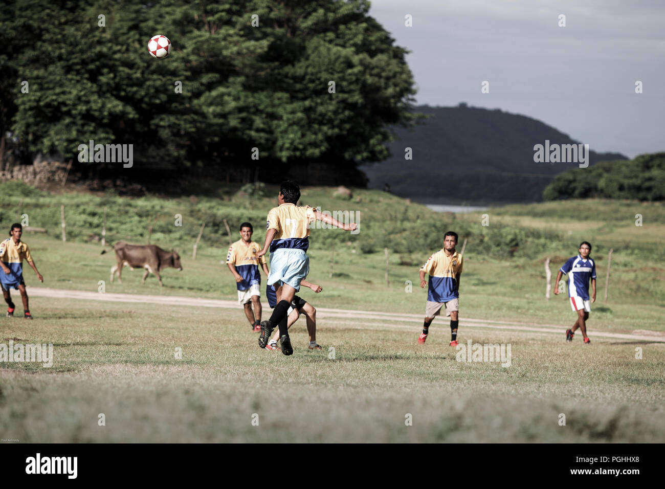 Men playing game of football on natural field in Suchitoto, El Salvador Stock Photo Alamy
