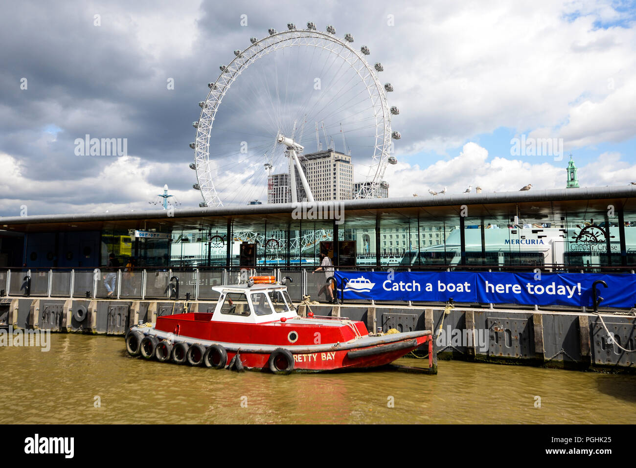 Westminster Pier jetty, Victoria Embankment, London, UK, on the River Thames. Small vessel Pretty Bay and London Eye Millennium Wheel Stock Photo