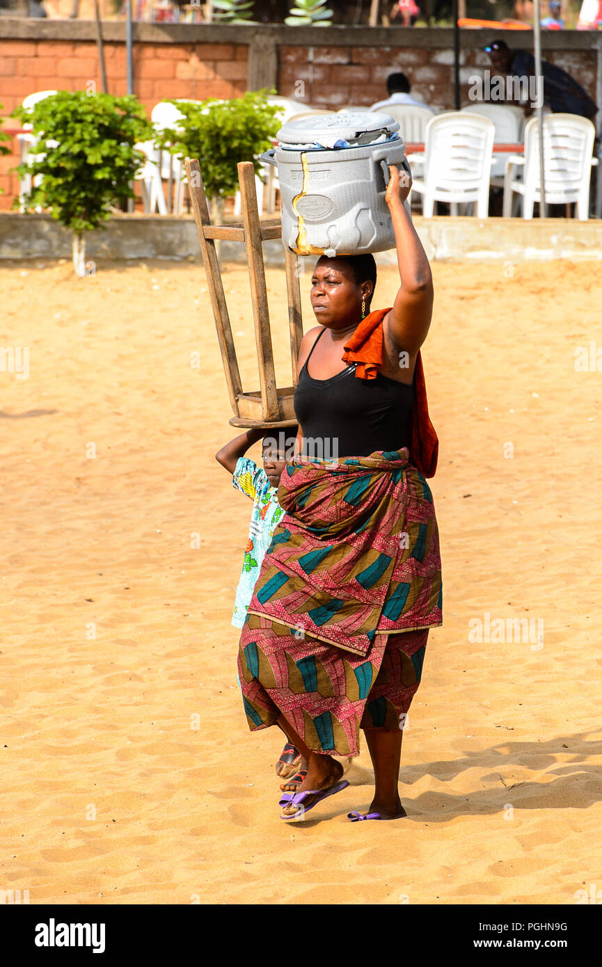 OUIDAH, BENIN - Jan 10, 2017: Unidentified Beninese woman carries a