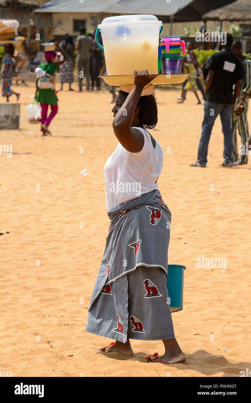 OUIDAH, BENIN - Jan 10, 2017: Unidentified Beninese woman carries a