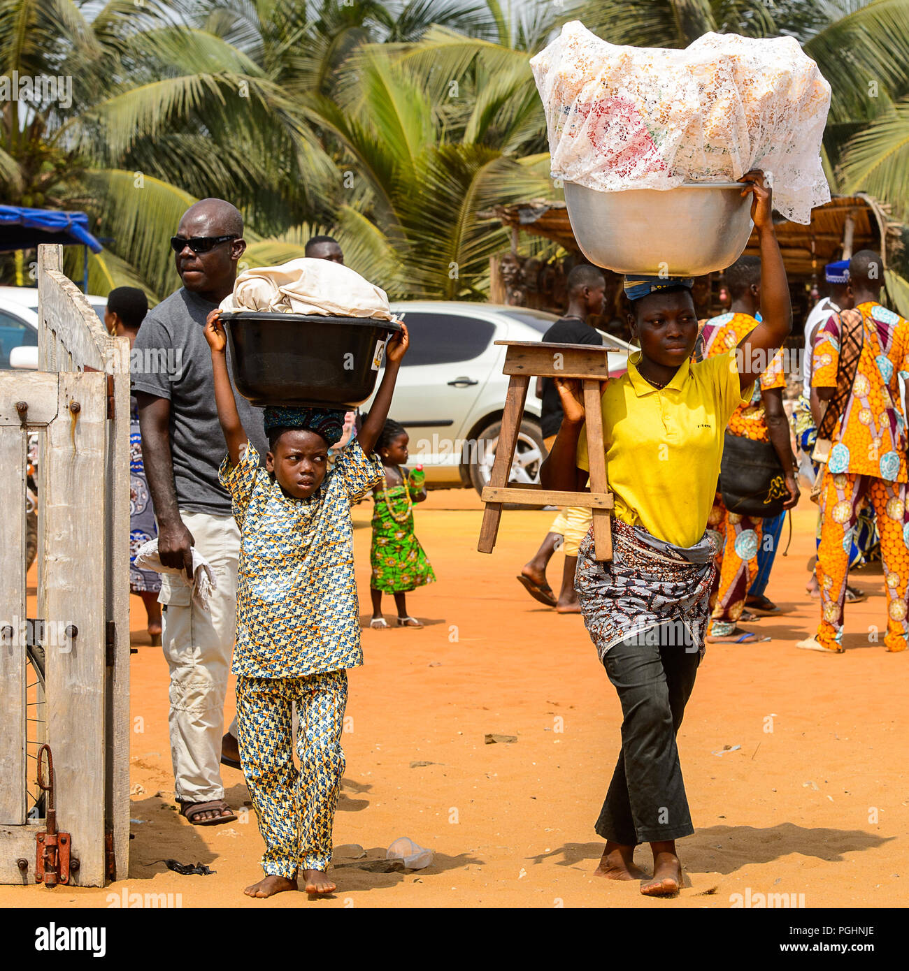 OUIDAH, BENIN - Jan 10, 2017: Unidentified Beninese people carry basins
