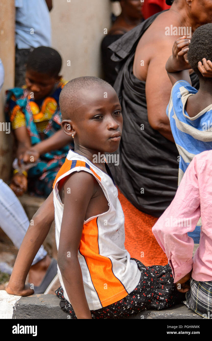 KUMASI, GHANA - Jan 16, 2017: Unidentified Ghanaian little girl with short  haircut sits in the crowd. People of Ghana suffer of poverty due to the bad  Stock Photo - Alamy