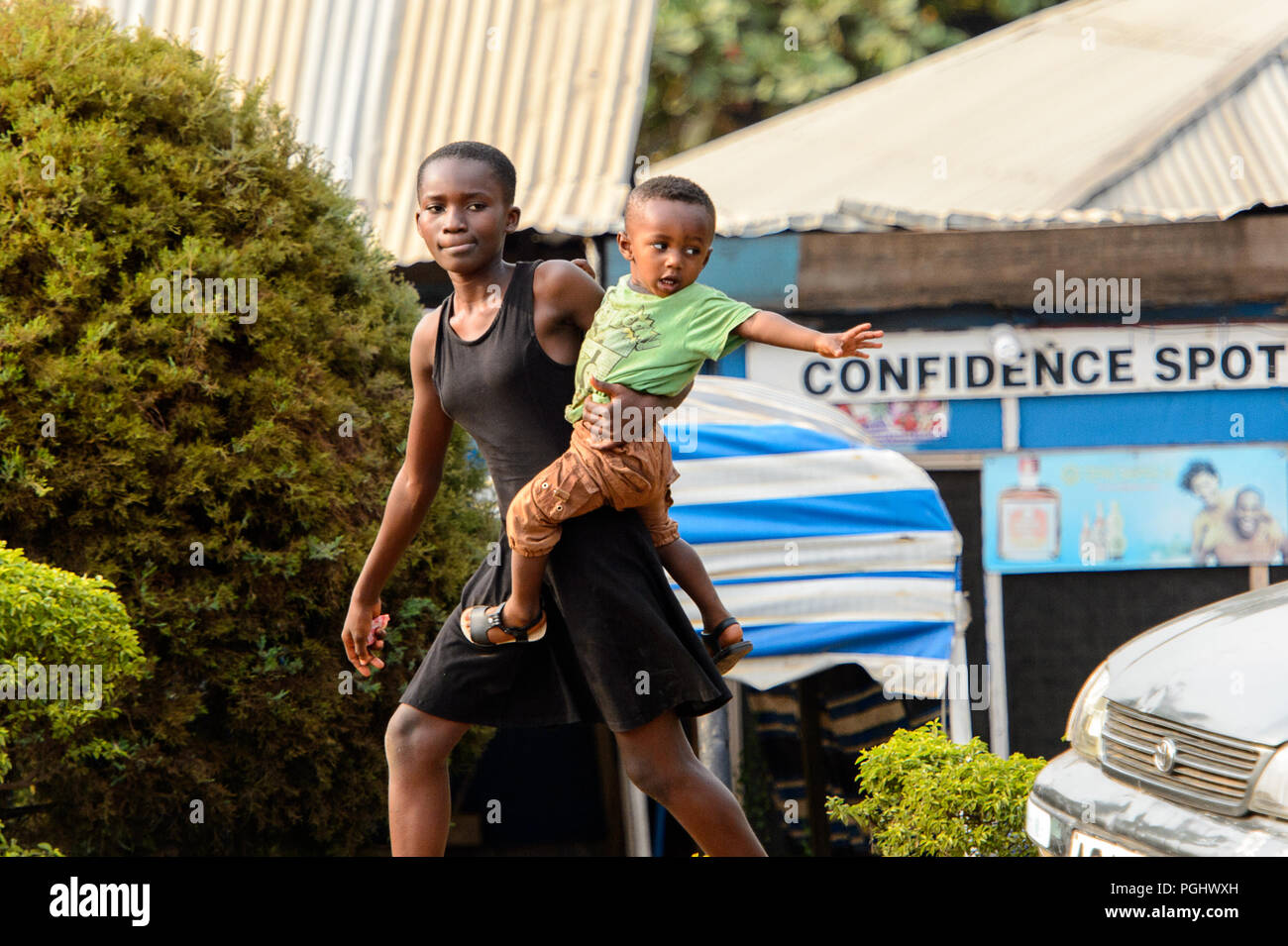 KUMASI, GHANA - Jan 16, 2017: Unidentified Ghanaian woman carries her baby. People of Ghana suffer of poverty due to the bad economy Stock Photo