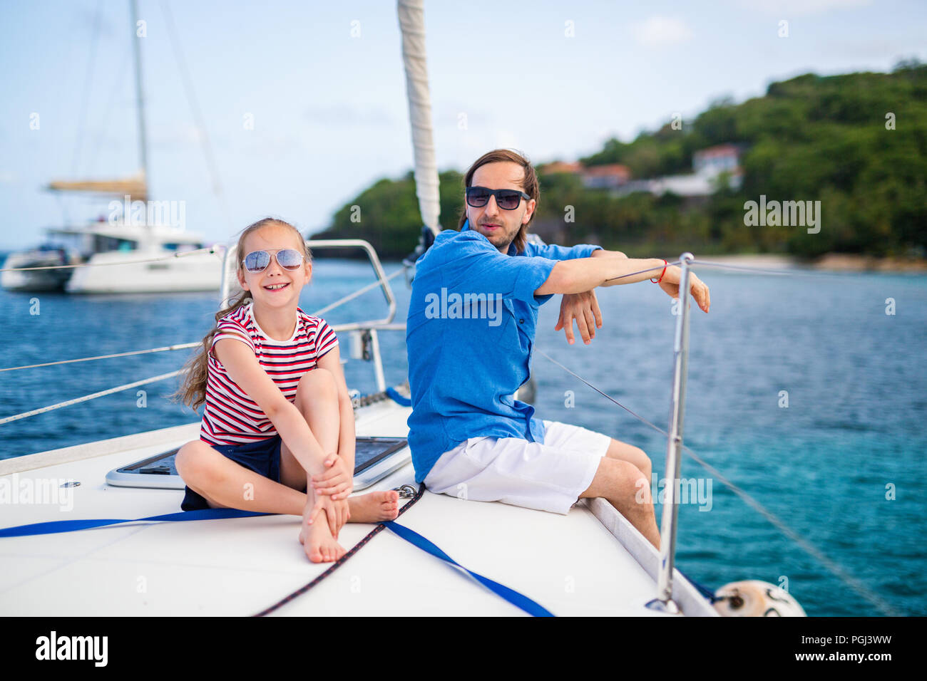 Father and daughter on board of sailing yacht having summer travel adventure Stock Photo