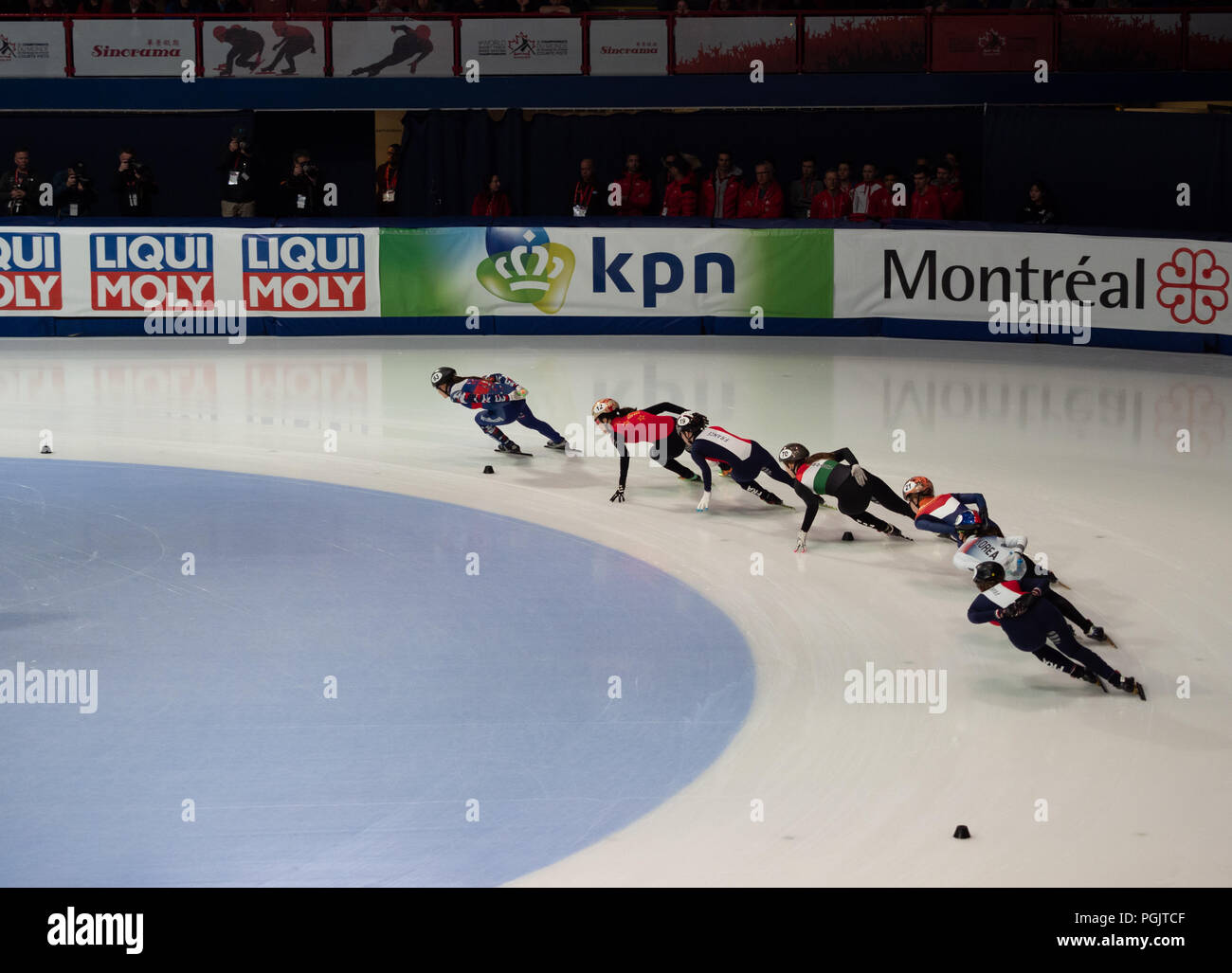 Seven female short track speed skaters rounding a corner with Russian skater, Ekaterina Efremenkova leading the race at Montreal's ISU World Cup on Ma Stock Photo