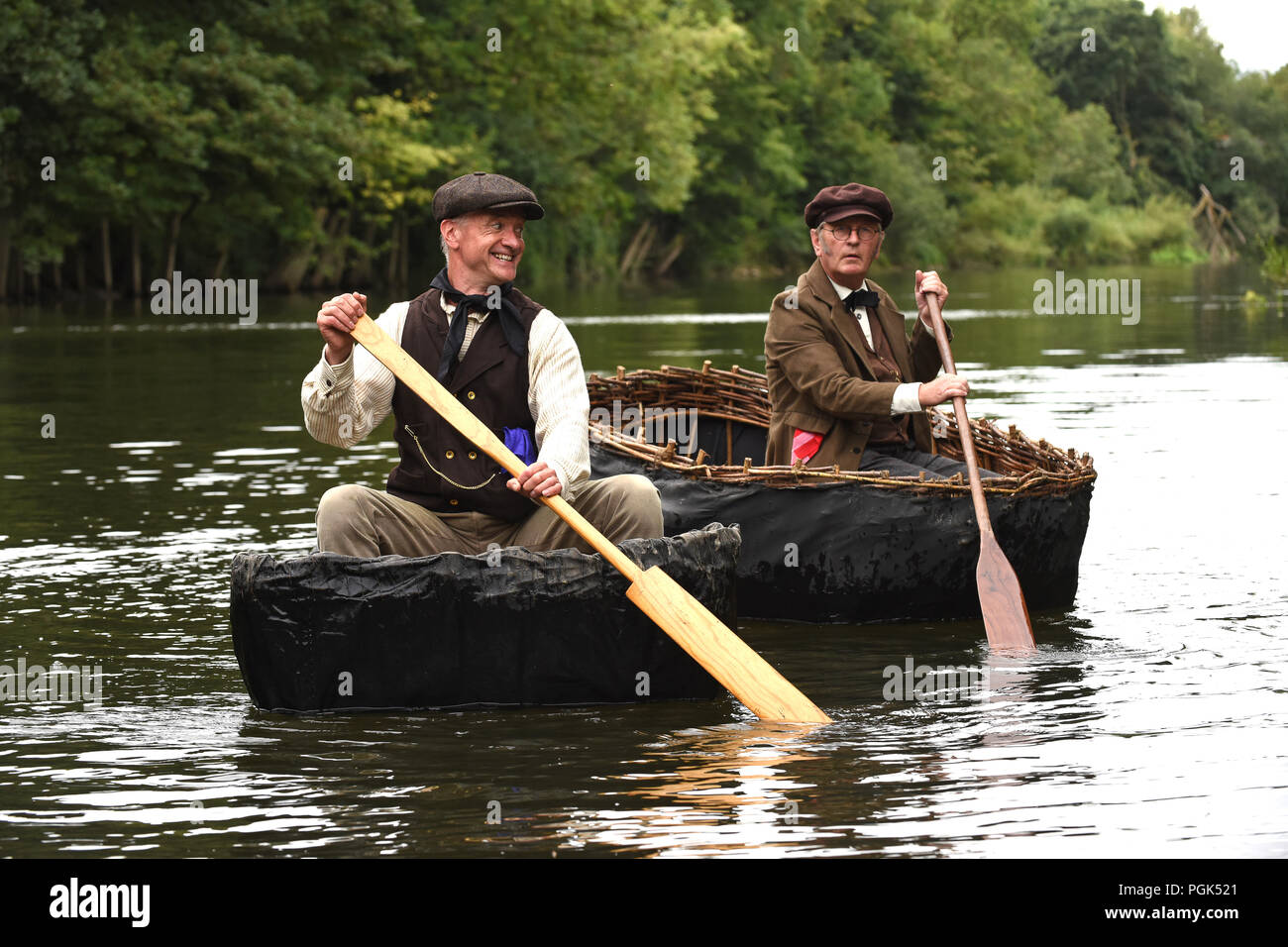 Time for a bit of nostalgia from coracle makers Richard Taylor and Conwy Richards at the annual bank Holiday Coracle regatta on the River Severn in Ironbridge. Credit: David Bagnall/Alamy Live News Stock Photo