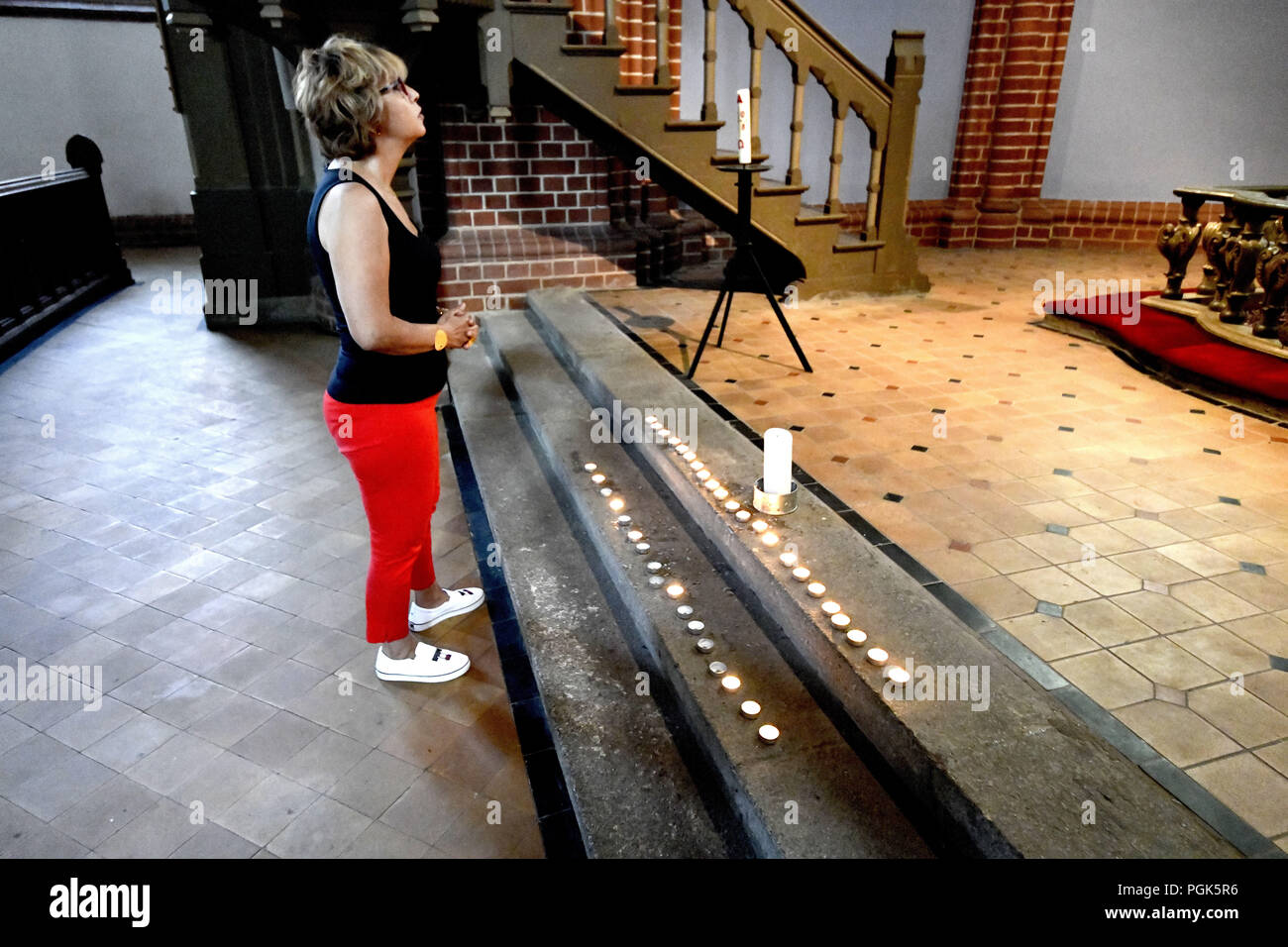 A Visitor To The St Mary S Church In Usedom Stands In Front Of
