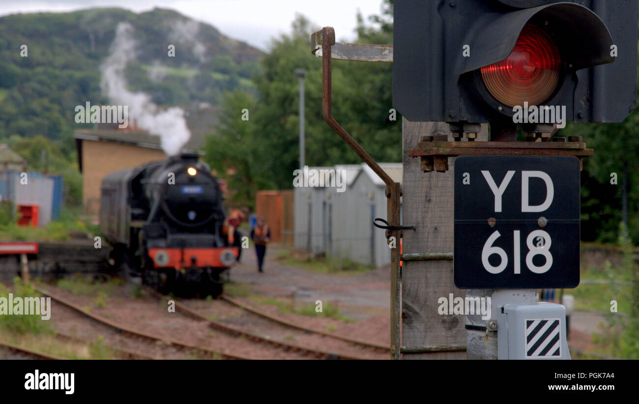 Glasgow, Scotland, UK. 27th  August, 2018. Locals where treated to a bit of living history as The Glasgow Highlander steam locomotive  spent overnight  taking on water and cleaning its firebox  in a siding at Dunbarton central before heading North to the touristic highland line as a replacement being relieved  of its duty in the borders Tweedbank line. Gerard Ferry/Alamy news Stock Photo