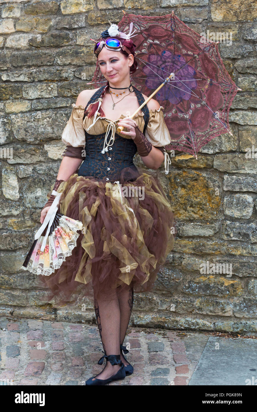 Lincoln, UK. 27th Aug 2018. The Asylum Steampunk Festival at Lincoln, in its 10th year, attracts visitors from all over the world. The biggest and longest steampunk festival in Europe, celebrates a steam powered world in the late 19th century, dressing in Victorian style with accessories that look like parts of machinery, cogs and gears. Credit: Carolyn Jenkins/Alamy Live News - Steampunk Steampunk clothing fashion, Stock Photo