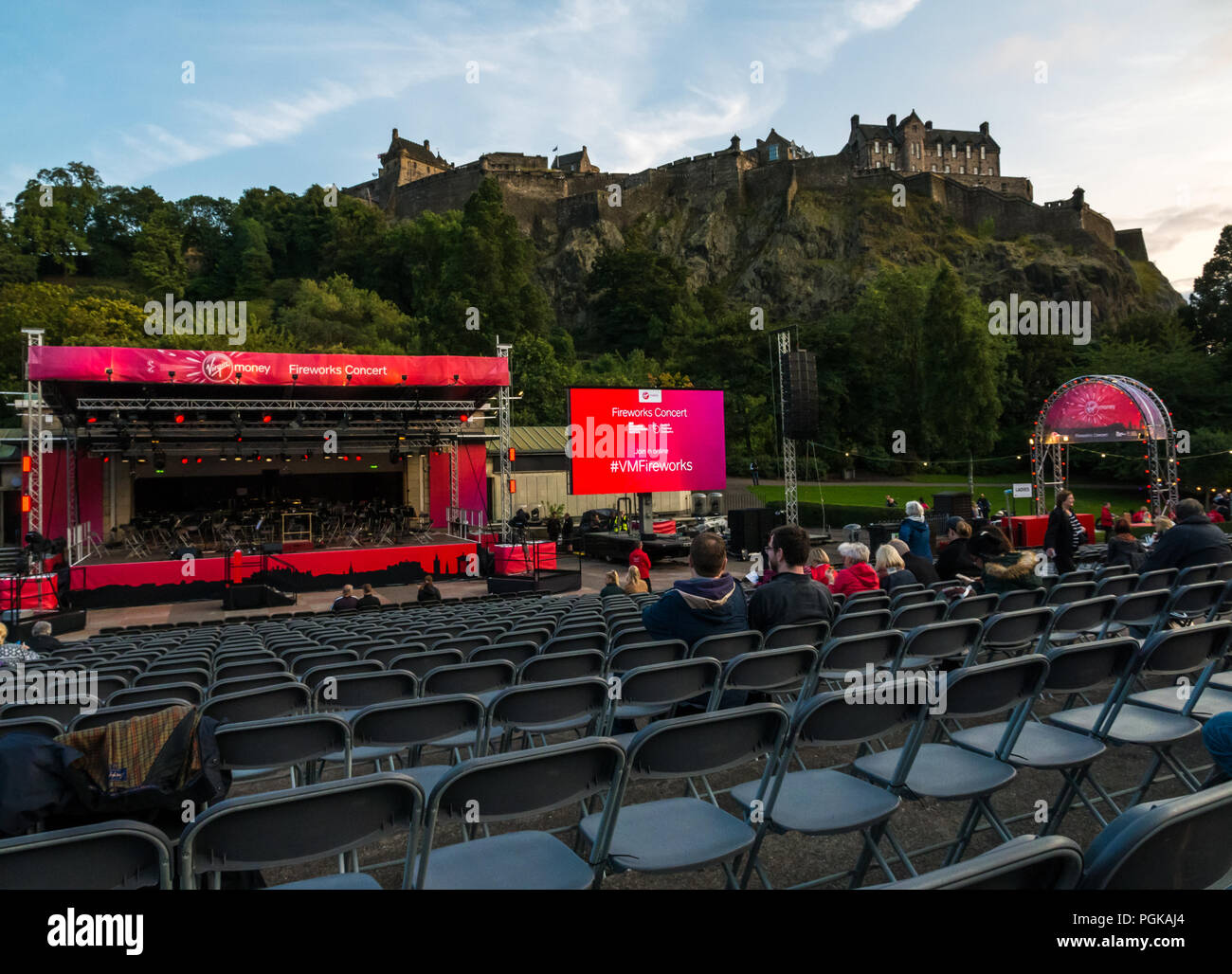 Princes Street Gardens, Edinburgh, Scotland, UK, 27th August 2018. Edinburgh International Festival finale Virgin Money sponsored fireworks. The Scottish Chamber Orchestra play selections from Holst's Suite The Planets choreographed with fireworks from Edinburgh Castle to end the Summer festival. The audience begins to arrive at the Ross bandstand Stock Photo