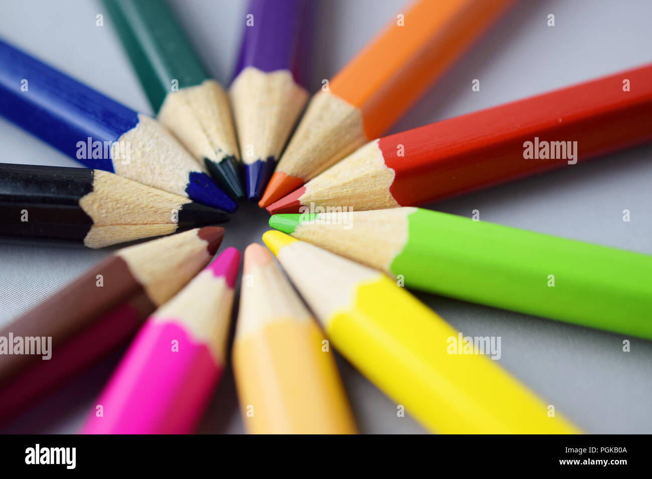 Many different colored pencils on gray background Stock Photo