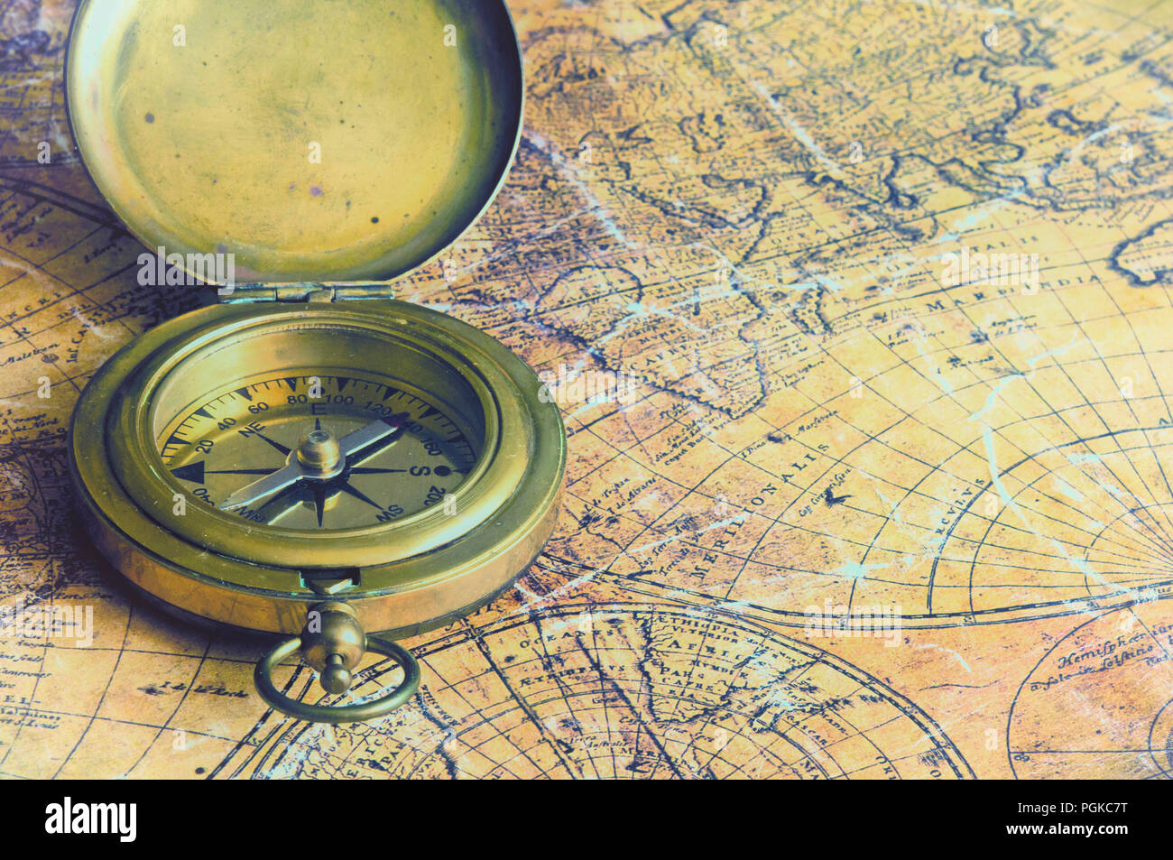old map of the world and antique brass compass Stock Photo