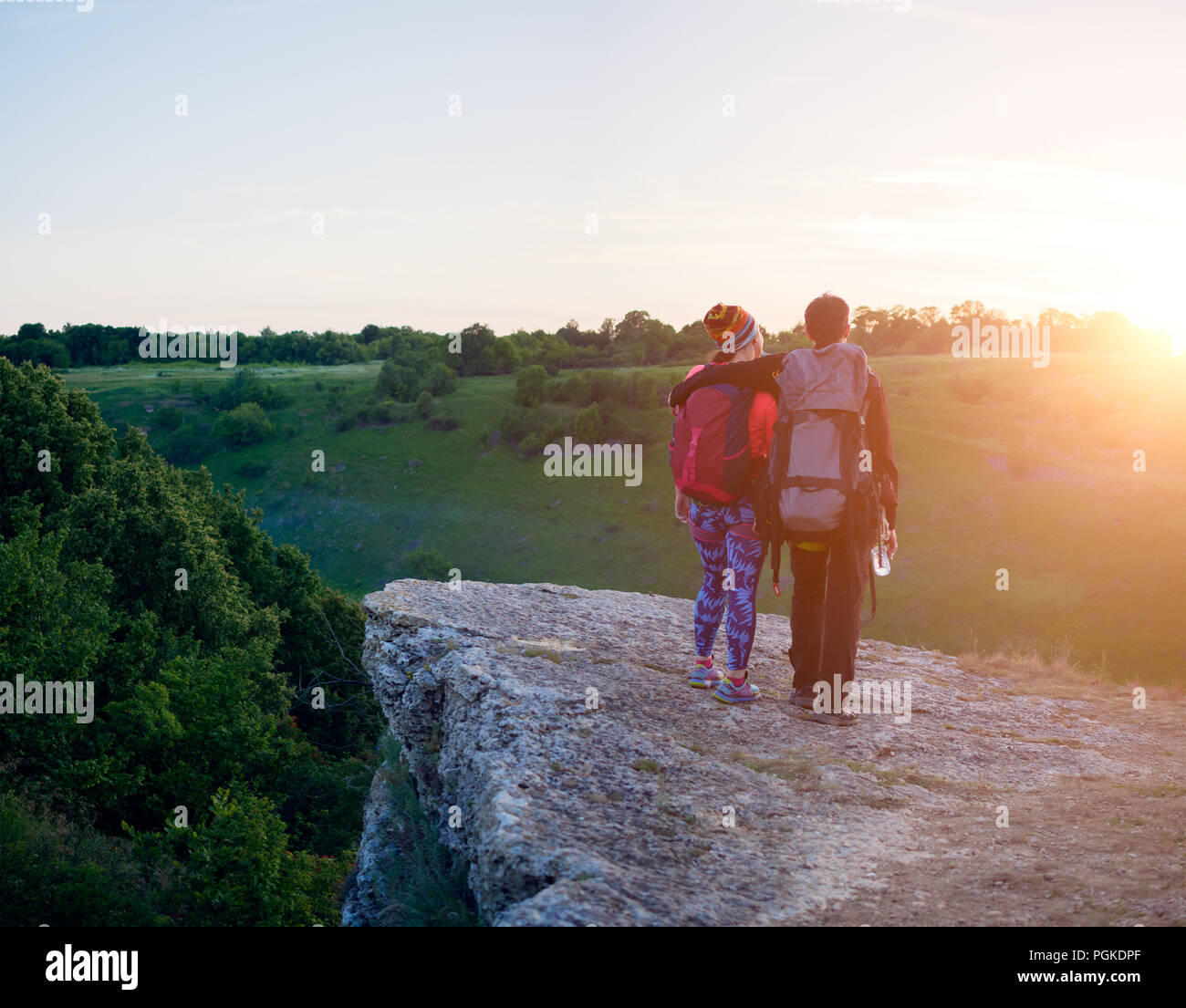 Photo of photo from back of hugging man and woman of tourists on hill ...