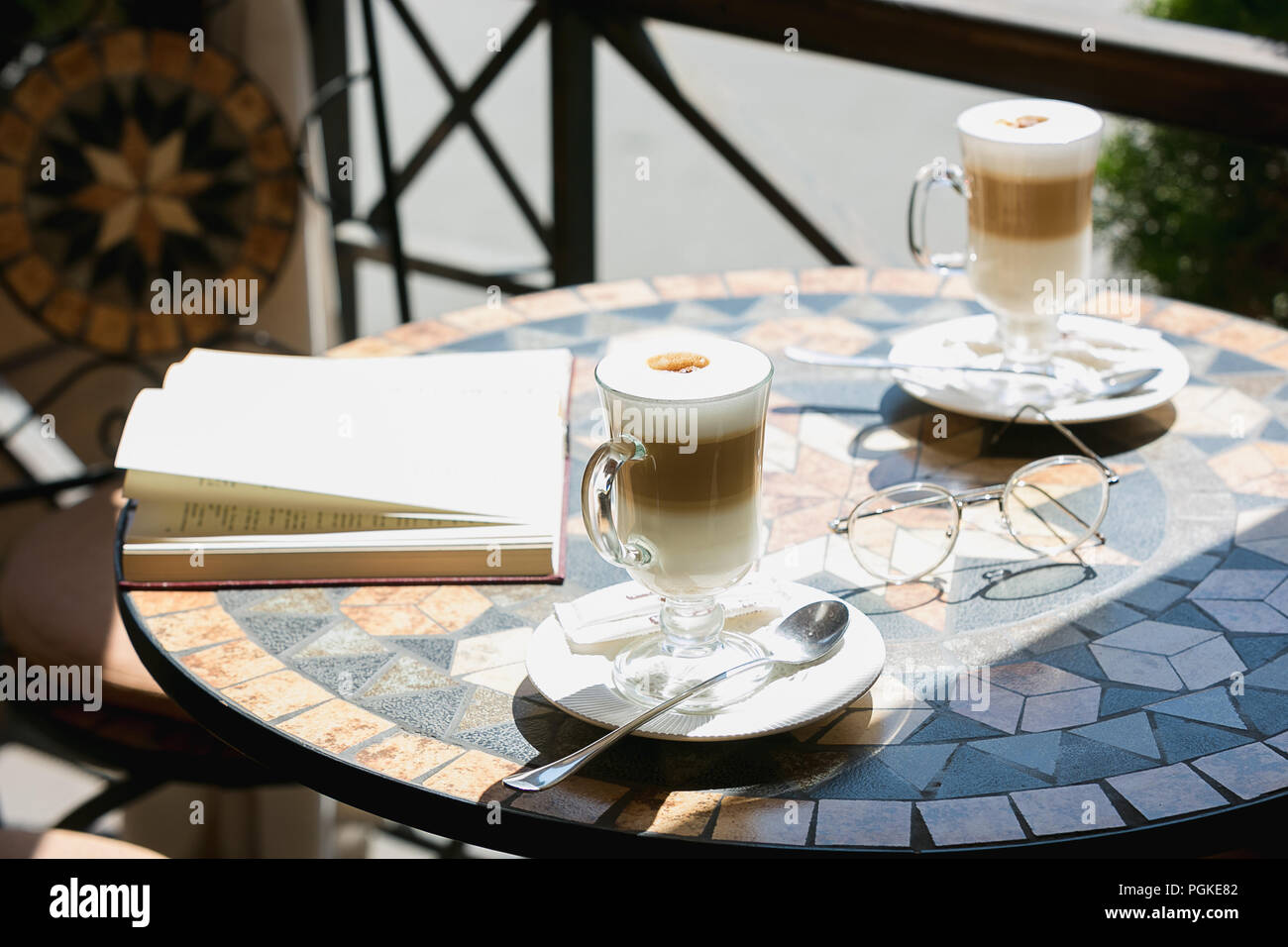 The two cups of coffee with book on table in room Stock Photo