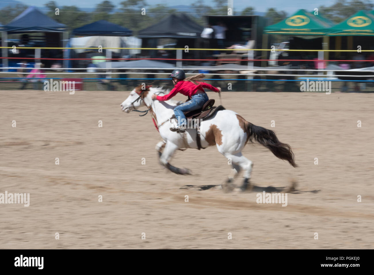 Woman rider competing in the barrel race at Mareeba rodeo, Far North Queensland, FNQ, QLD, Australia Stock Photo
