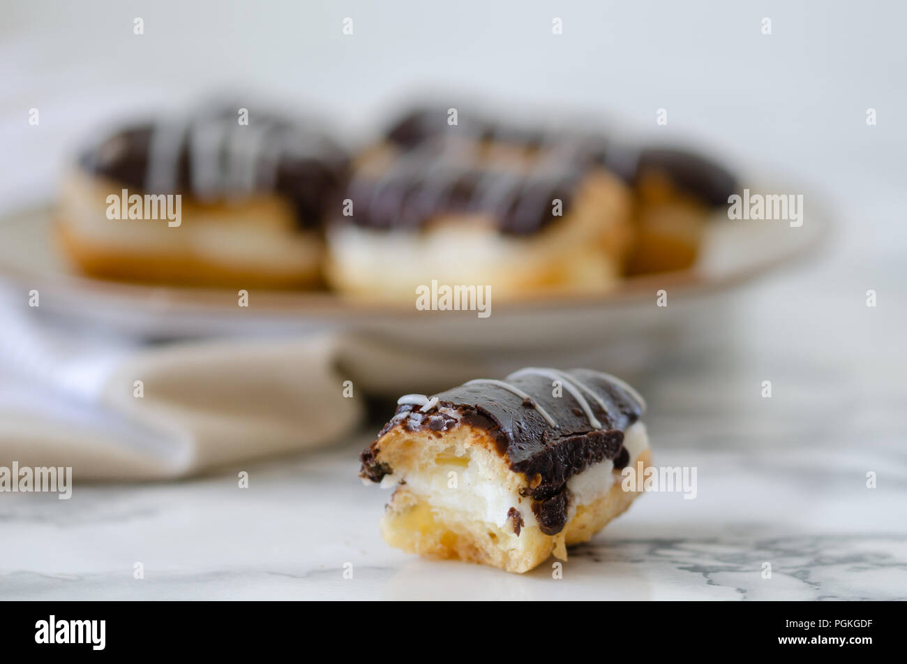 Traditional French dessert on a white background.There is a bite of eclair . Stock Photo