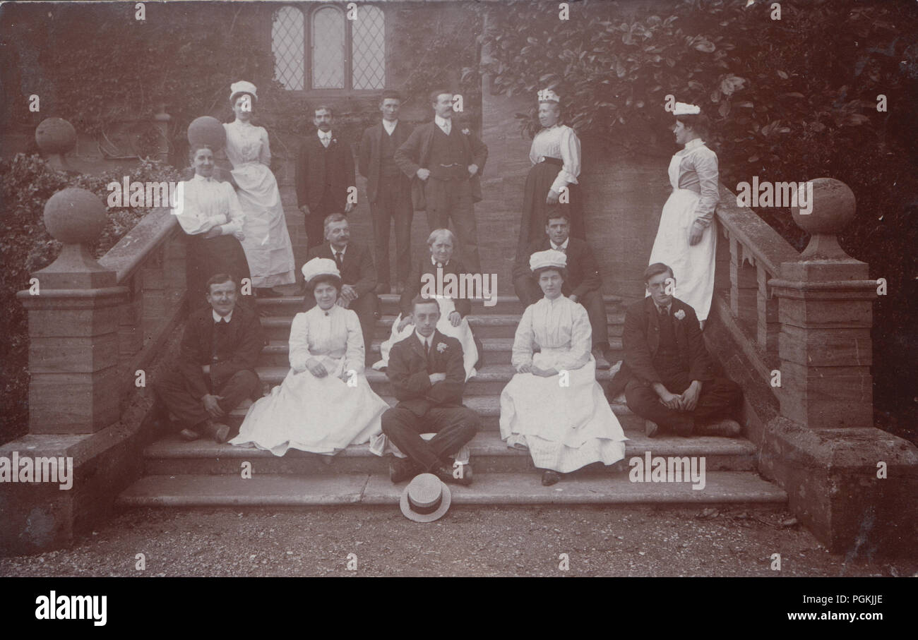 Vintage Photograph Showing a Group of Domestic Staff Posing on The Steps of a Grand House. Possibly on The Occasion of a Wedding. Stock Photo