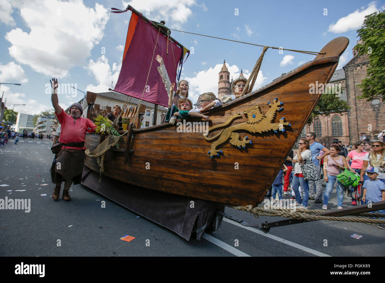 Worms, Germany. 26th Aug, 2018. People in medieval costumes ride in a boat in the parade. The first highlight of the 2018 Backfischfest was the big parade through the city of Worms with over 70 groups and floats. Community groups, music groups and businesses from Worms and further afield took part. Credit: Michael Debets/Pacific Press/Alamy Live News Stock Photo
