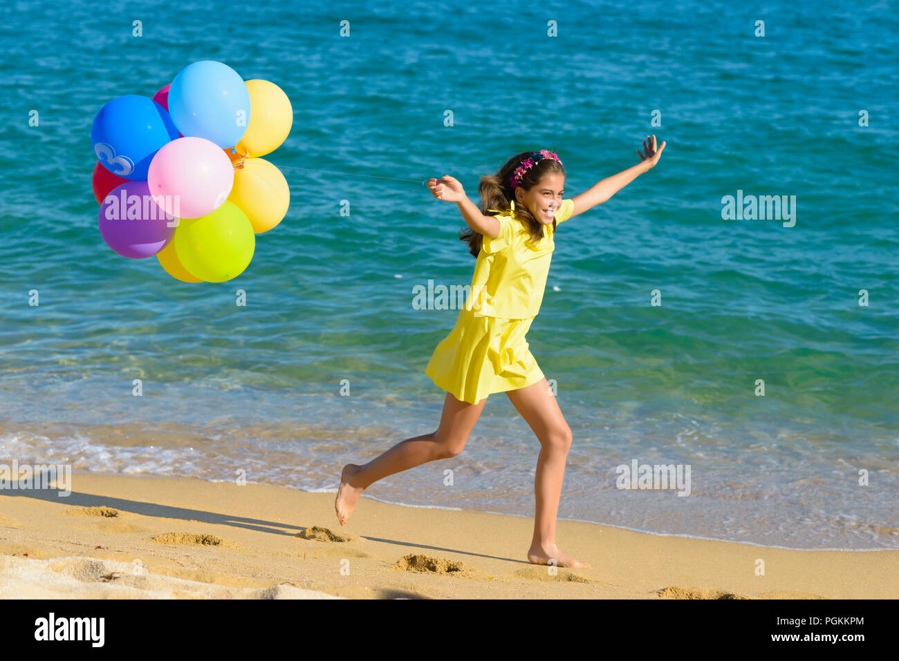 Girl holding balloons hi-res stock photography and images - Alamy
