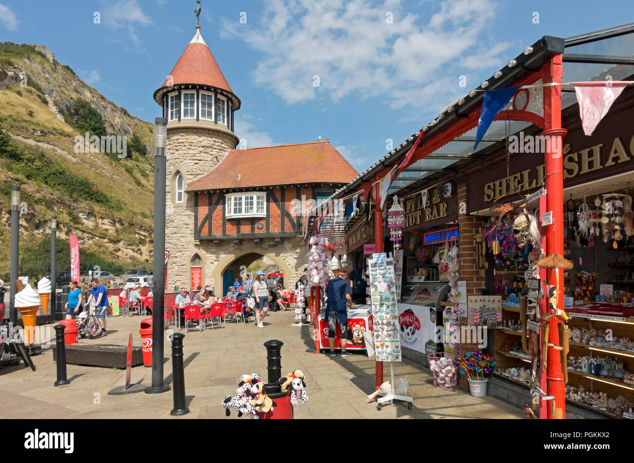 People tourists visitors outside shops and cafes in summer South Toll House Marine Drive Scarborough North Yorkshire England UK Great Britain Stock Photo