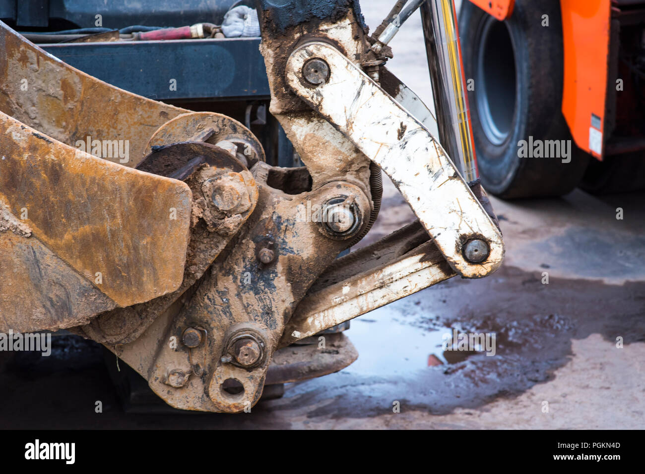 bulldozer, excavator close-up, heavy metal equipment with iron ladle and large wheels at work in the sand quarry, excavations of sand, earth and soil, industrial site, construction site Stock Photo