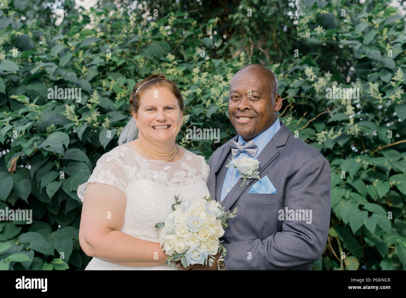 Mixed Race older couple getting married Stock Photo