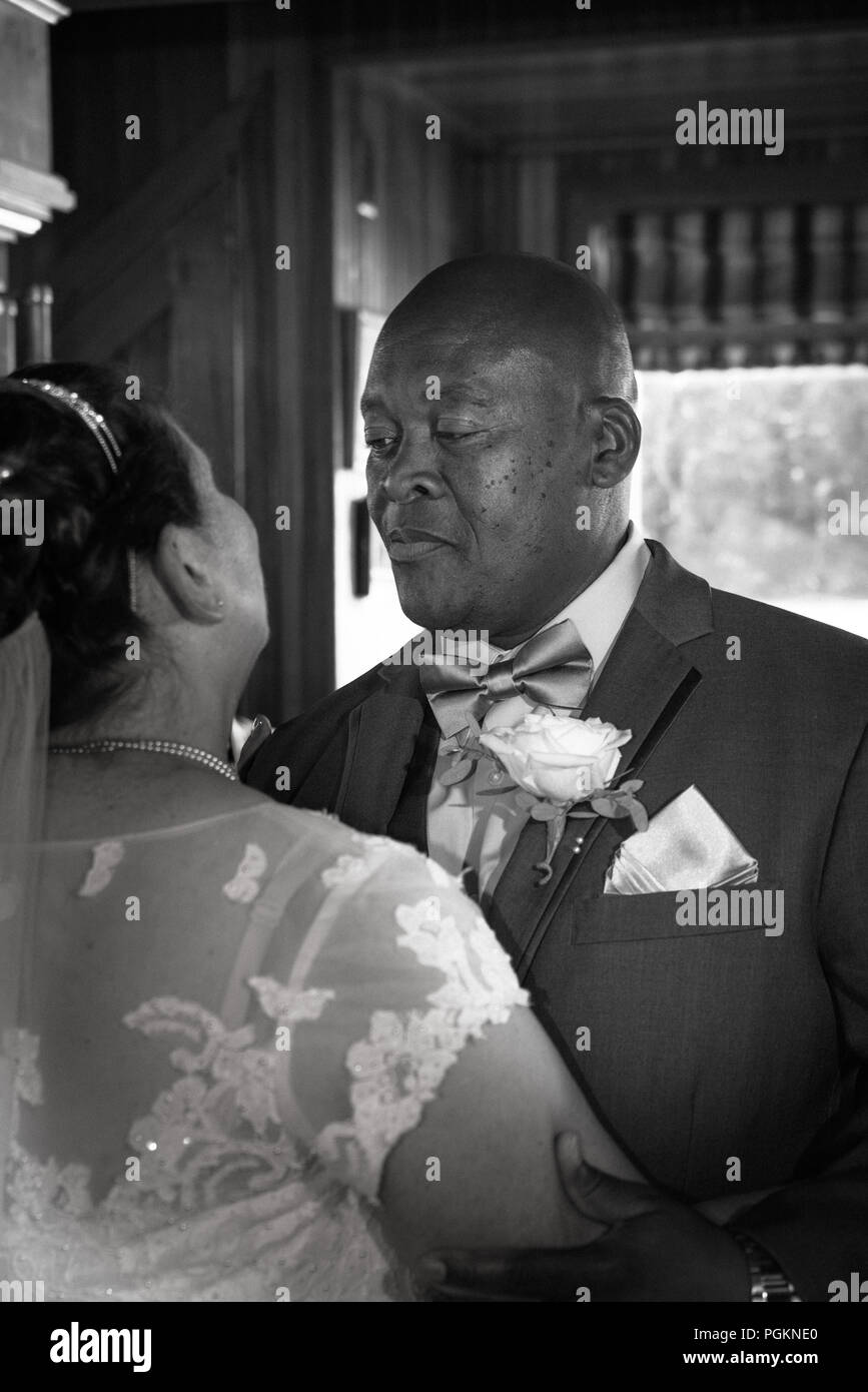 Mixed race older couple dancing Stock Photo