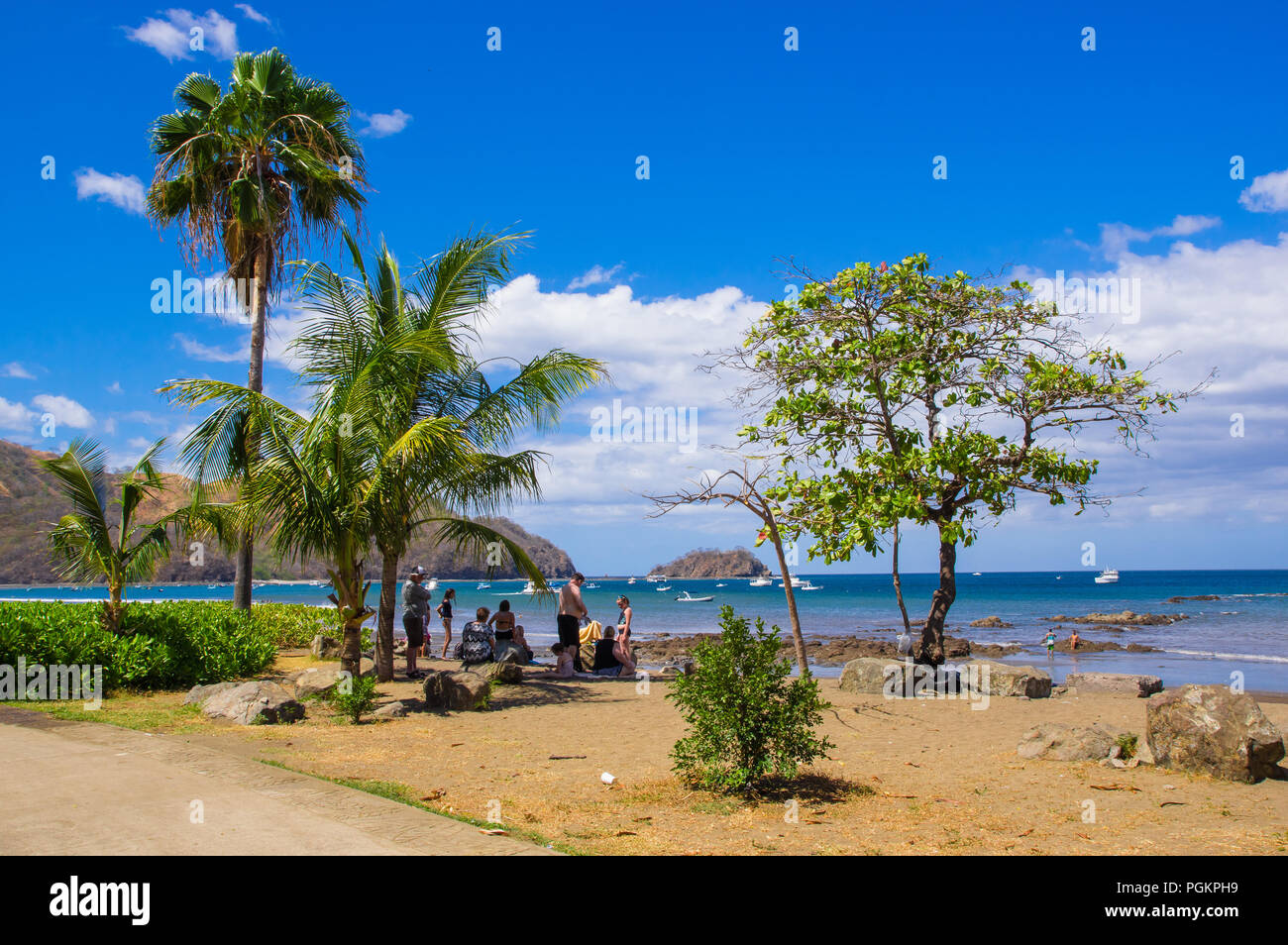 Monterrico, Santa Rosa, Guatemala, June, 28, 2018: Unidentified people in the beach taking the sun and enjoying the beautiful landscape of Coconut on  Stock Photo