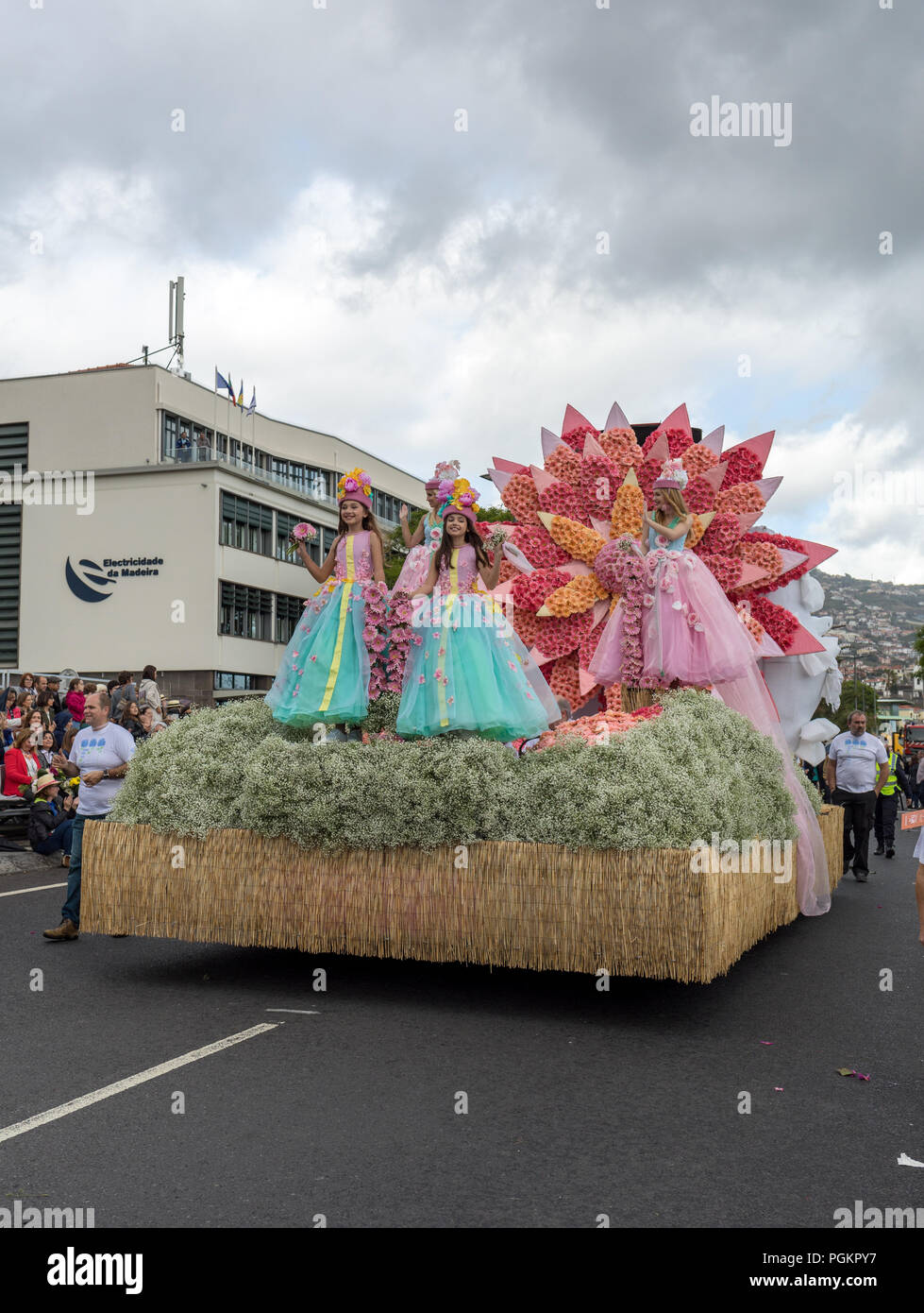 Funchal; Madeira; Portugal - April 22; 2018: Girls in colorful costumes on the floral float at Madeira Flower Festival Parade in Funchal on the Island Stock Photo