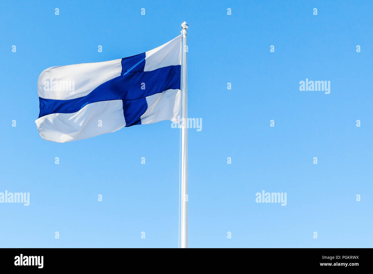 Flag of Finland or Blue Cross Flag over blue sky background Stock Photo