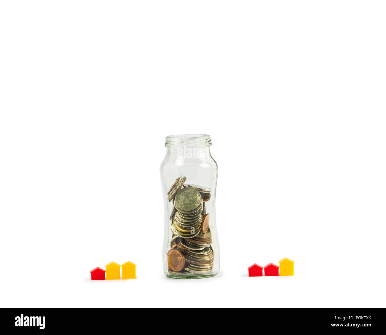 Investment Savings: Growing money for Home Loan Concepts: Full Coins in Clear Glass Bottles with a Small House or Hotel on a White Background include  Stock Photo