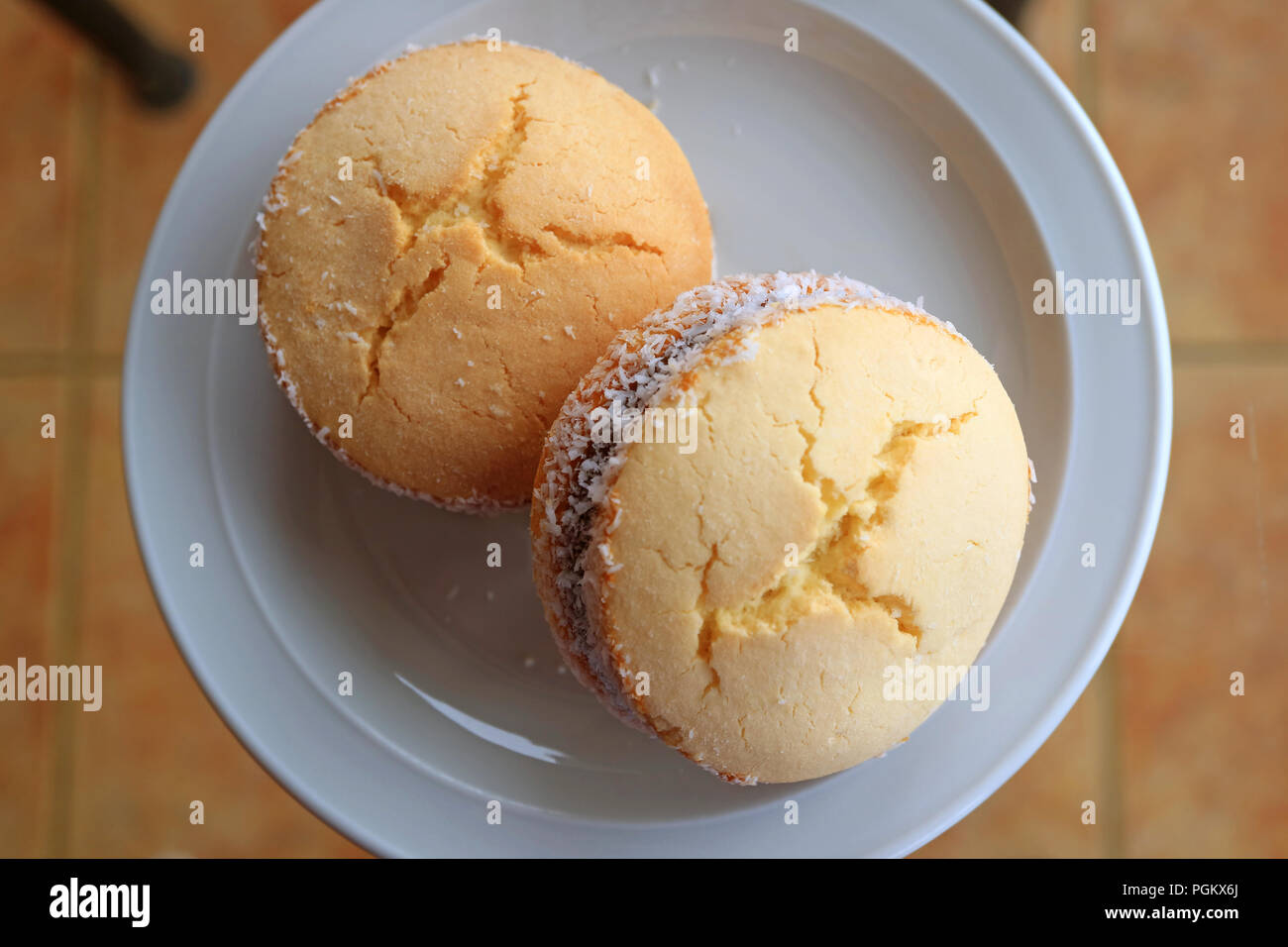Top view of a pair of Alfajores, traditional Latin American sweets served on glass top table Stock Photo