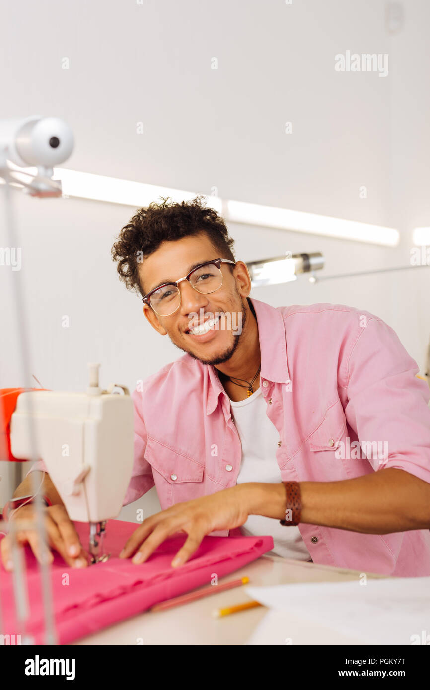 Positive tailor enjoying his work and smiling happily Stock Photo - Alamy