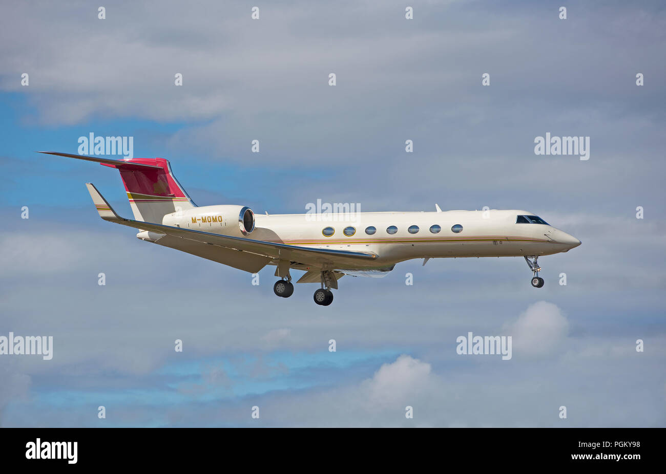 A Jersey registered Gulfstream 550 registration M-MOMO making its final approach into Inverness Dalcross Airport in the Scottish Highlands. Stock Photo