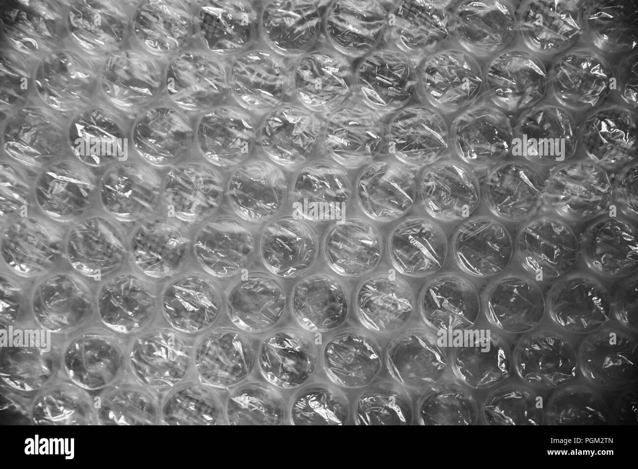 Bubble wrap texture used for packaging fragile items on grey background Stock Photo Alamy