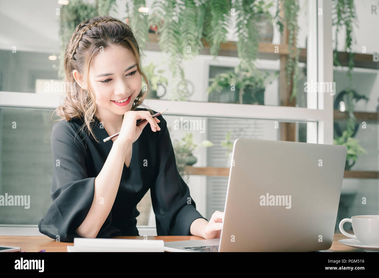 Confident happiness young woman working on laptop or notebook in her  office. Beautiful Freelancer Woman working online at her home. Beauty Asian  busin Stock Photo - Alamy