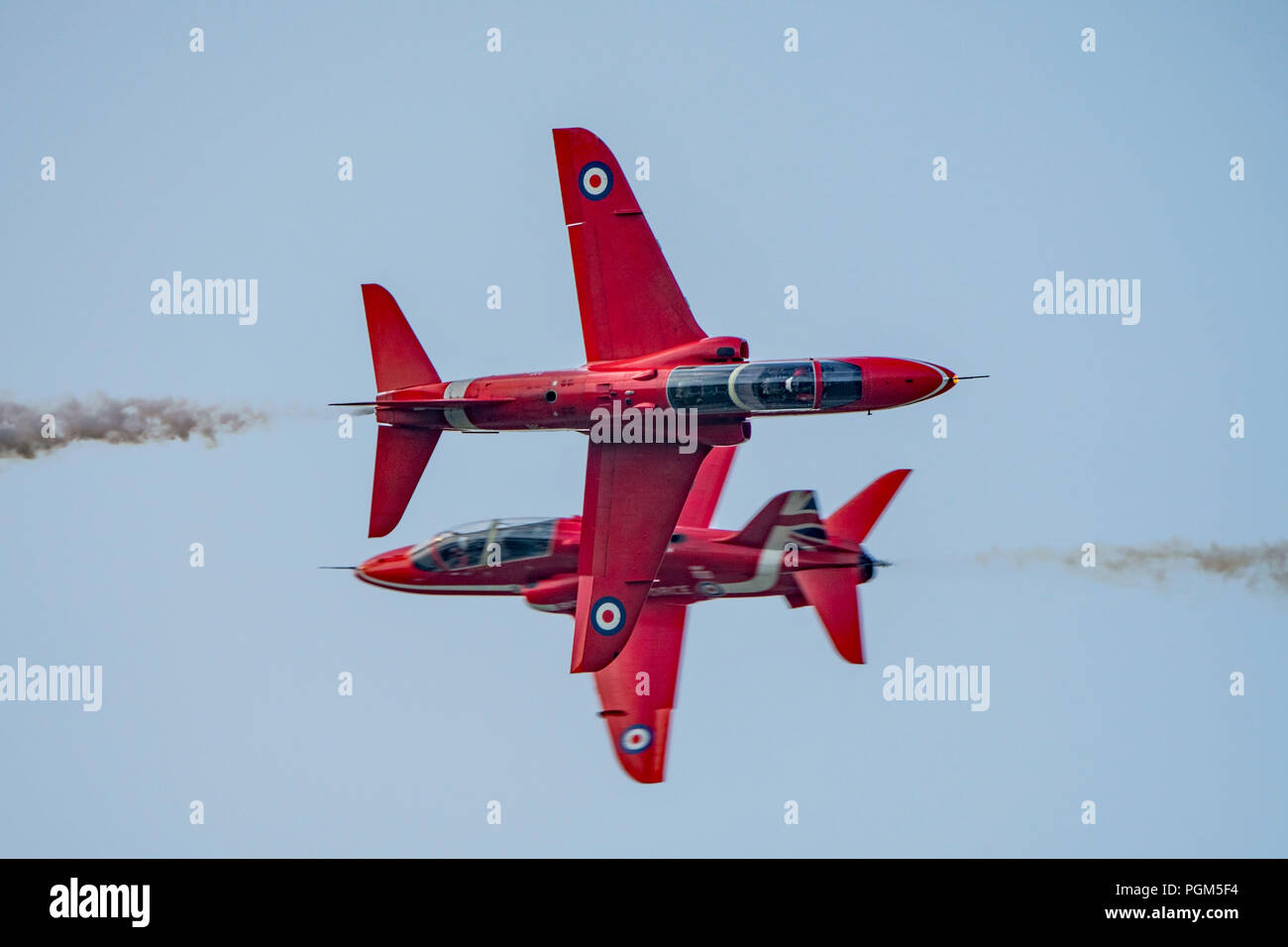 The RAF Red Arrows synchro pair aircraft perform the opposition pass at the Dunsfold Wings & Wheels Airshow, UK on the afternoon of 25th August 2018. Stock Photo