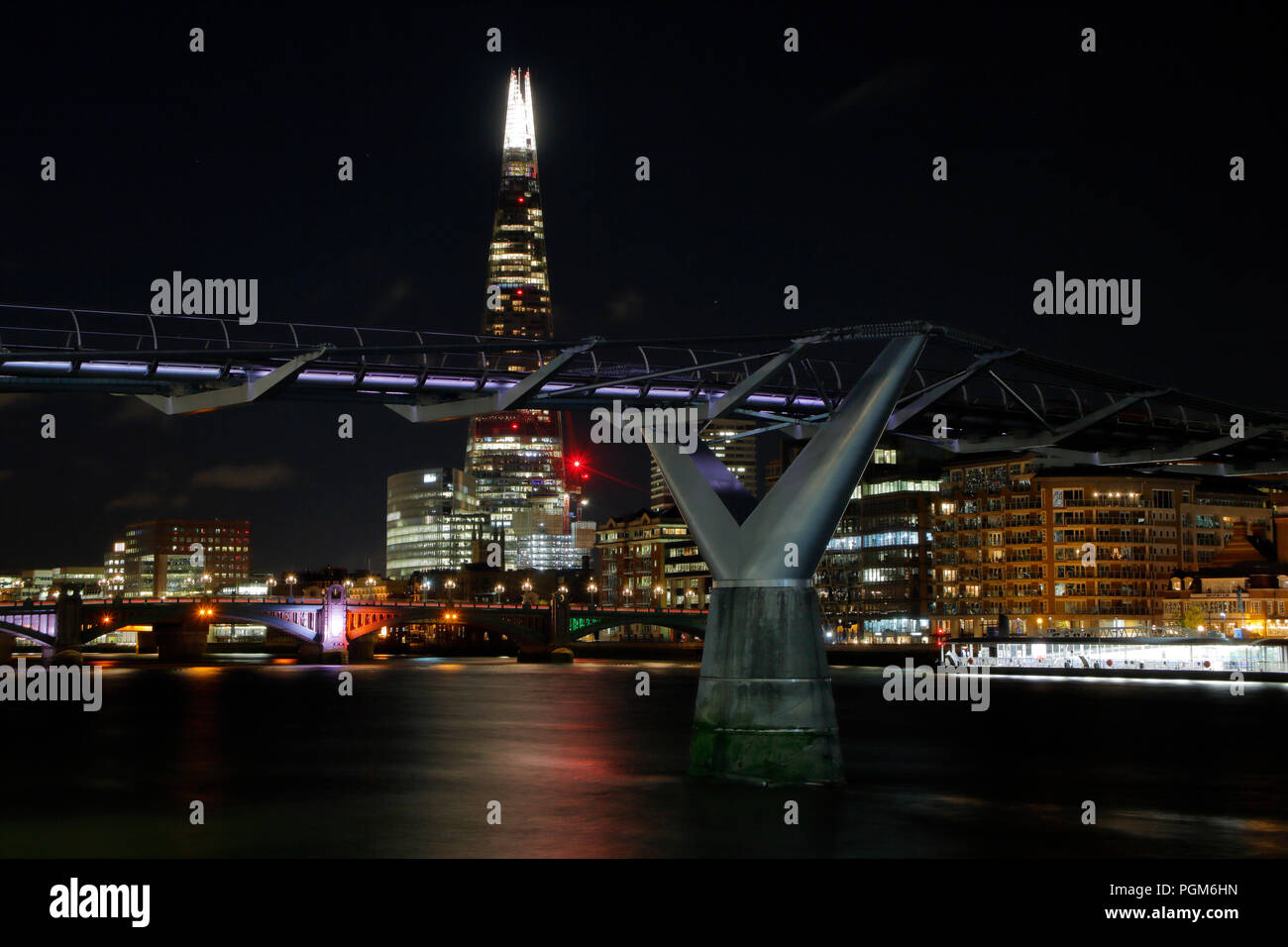 The Millennium Bridge and The shard, London, at night Stock Photo