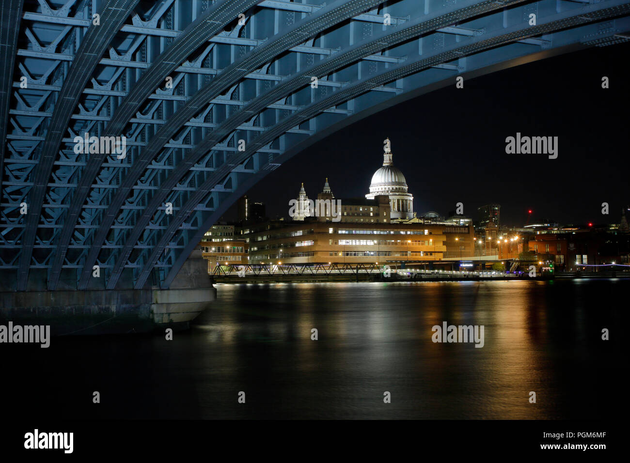 Saint Pauls Cathedral from under Blackfriars Bridge at night, bridge structure has been light
