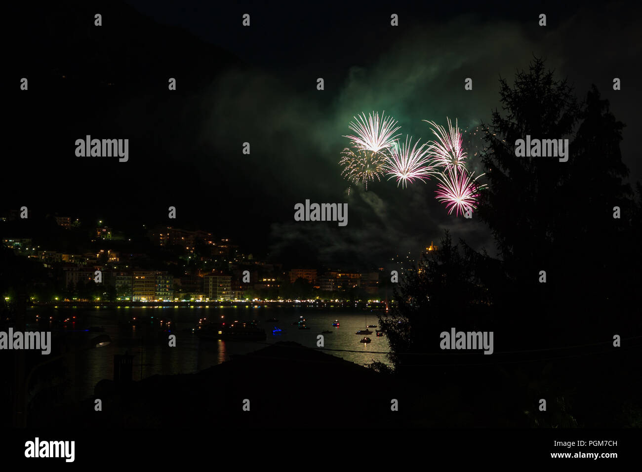 panoramic view of omegna during a fireworks display during the San Vito festival Stock Photo