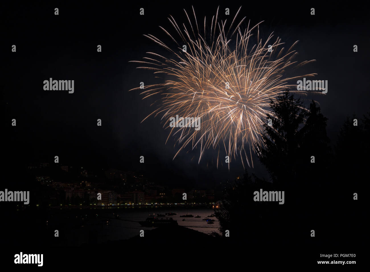 panoramic view of omegna during a fireworks display during the San Vito festival Stock Photo