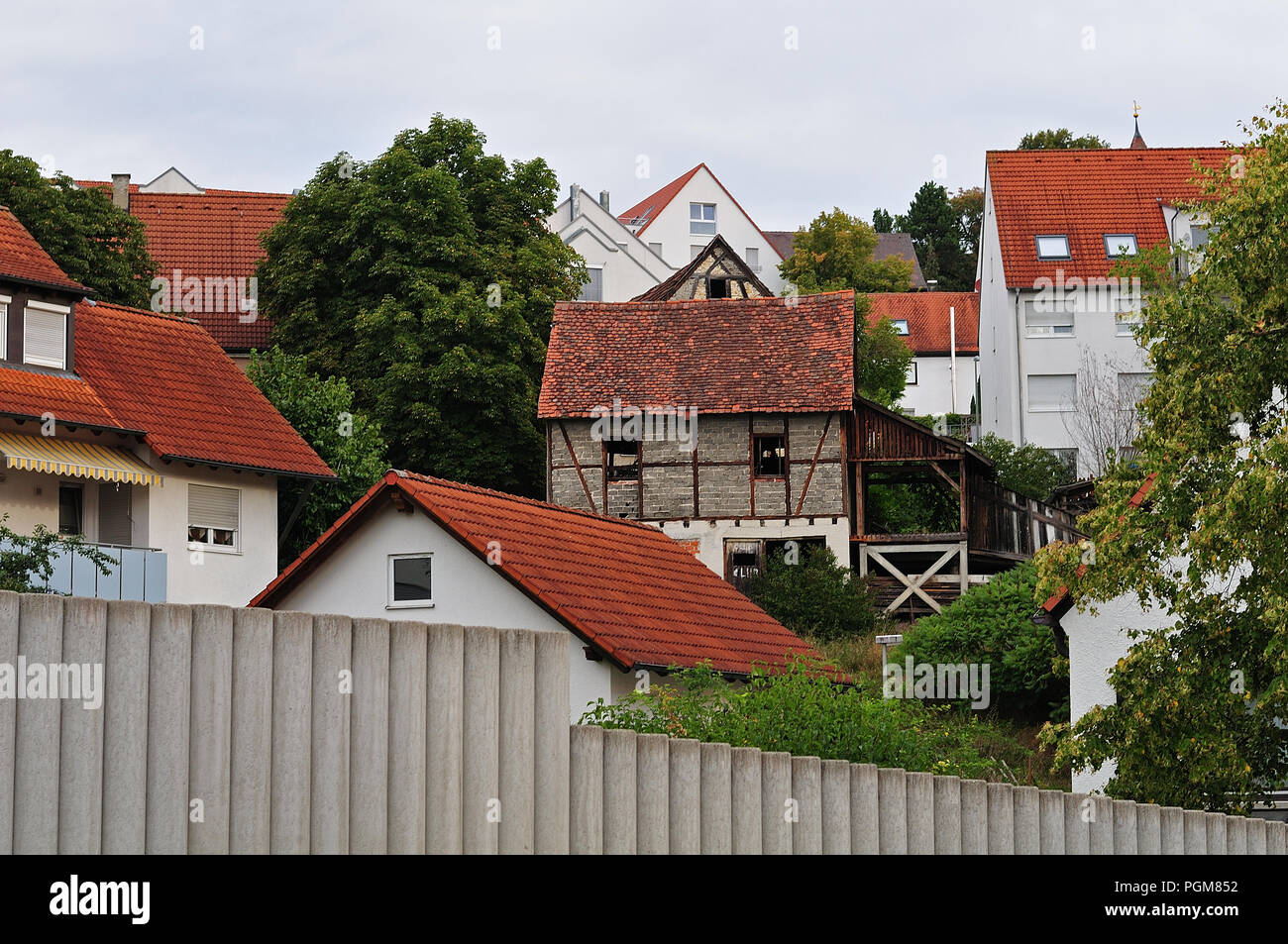 village with buildings at slope, tumbledown old hut in the middle of them Stock Photo