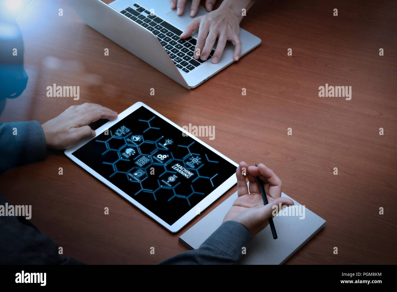 Machine learning technology diagram with artificial intelligence (AI),neural network,automation,data mining in VR screen. two colleagues discussing da Stock Photo