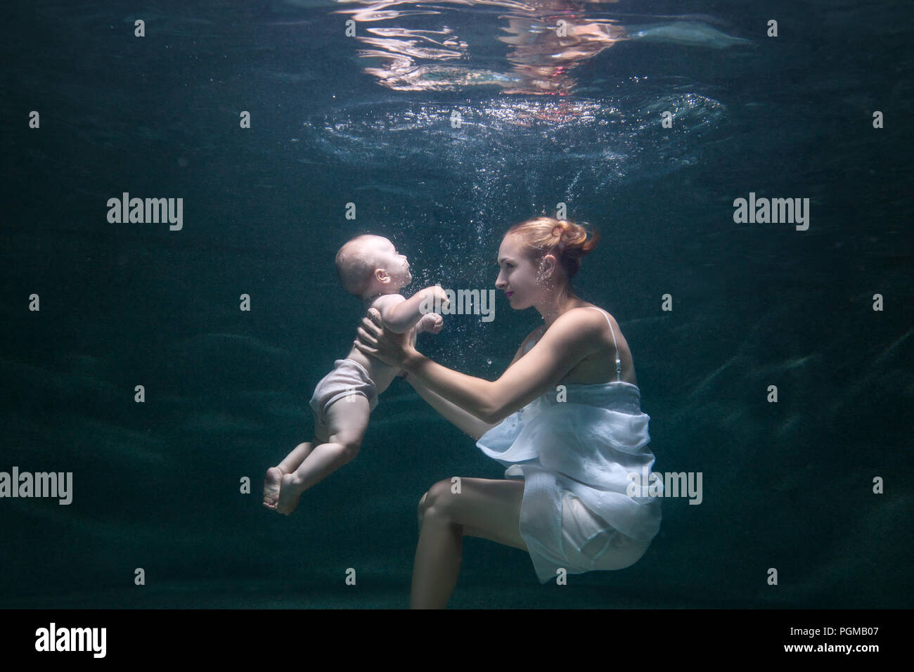 Mother teaches the baby to swim under water Stock Photo - Alamy