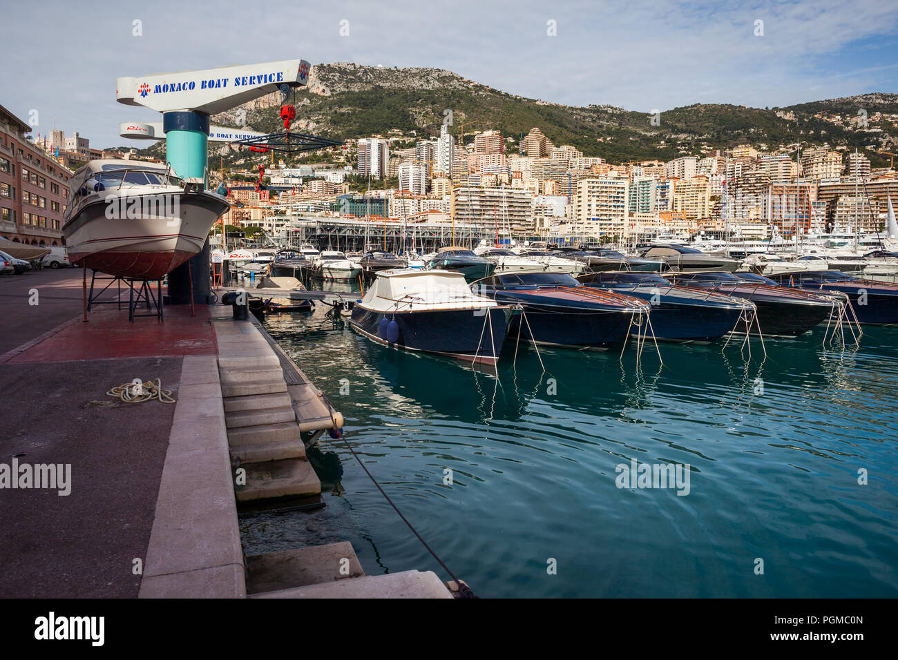 Port of Monaco, row of yachts, Boat Service at port quay and city skyline Stock Photo