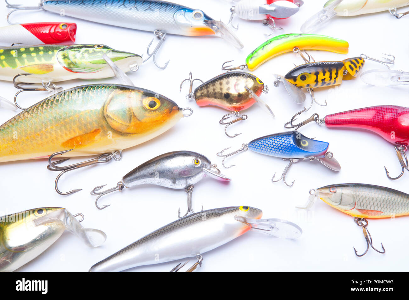A selection of mostly modern fishing lures, also known as plugs, equipped with treble hooks and designed for catching predatory fish. Fishing plugs ar Stock Photo